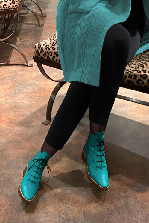 Turquoise blue women's ankle boots with laces at the front. Round toe. Low rubber soles. Worn view - Florence KOOIJMAN